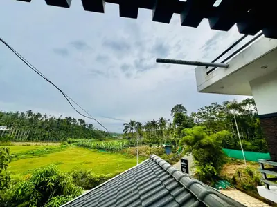 a view of a field from the roof of a house at Sands Villa Homestay in Wayanad