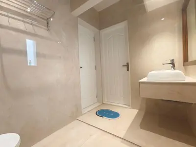 a bathroom with a sink and a toilet at Gulzar 1BHK Service Apartment, kannur in Kannur