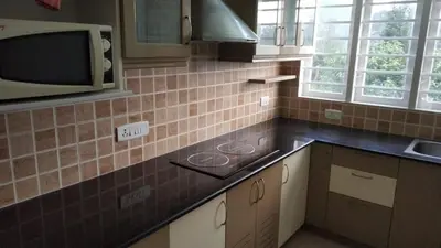 a kitchen with a sink and a microwave at FN's Eternia in Ooty