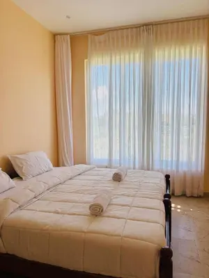 a large bed in a bedroom with a large window at blackdotstay-olive villa in Kodaikānāl