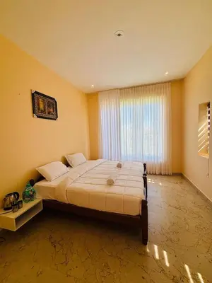 a bedroom with a large bed in front of a window at blackdotstay-olive villa in Kodaikānāl