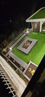 an aerial view of a garden at night at blackdotstay-olive villa in Kodaikānāl