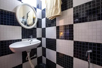 a bathroom with a sink and a mirror at Misty Creek Homestay in Vālpārai