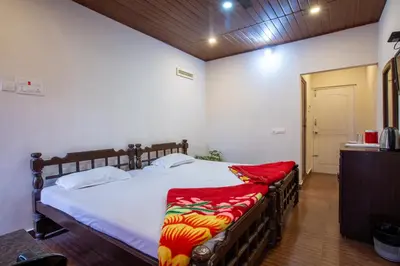 a bedroom with a large bed in a room at Misty Creek Homestay in Vālpārai