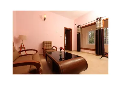 a living room with a couch and a table at The Forest Haven in Ooty