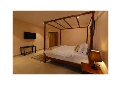a bedroom with a large bed with a canopy at The Forest Haven in Ooty