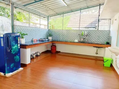 a large room with a counter and some windows at Boganvilla, Magic Land Resort in Athirappilly
