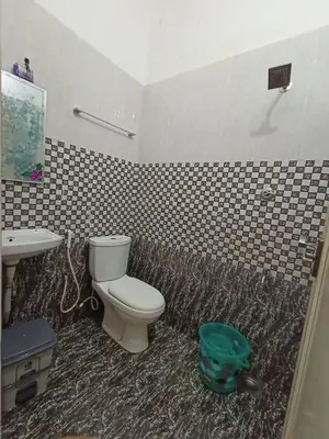 a bathroom with a toilet and a sink at Boganvilla, Magic Land Resort in Athirappilly