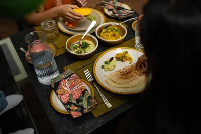a table with plates of food on top of it at Villa Vani in Mysore