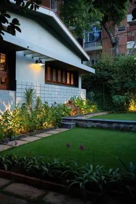 a house with a green lawn in front of it at Villa Vani in Mysore