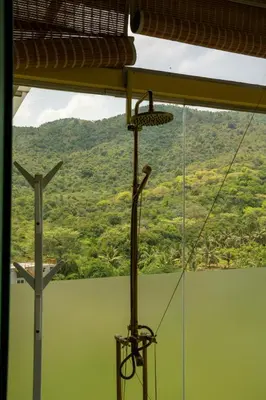 a view of a mountain from a room with a cross at Yanai at Anai - Private Pool & Private Cook in Varagampadi