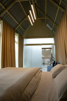 a bedroom with a large bed and a large window at Yanai at Anai - Private Pool & Private Cook in Varagampadi