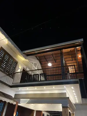 a balcony of a house at night at Wayanad Haven Villa in Wayanad