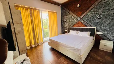 a bedroom with a bed and a large window at Wayanad Haven Villa in Wayanad