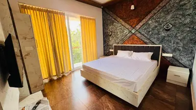a bedroom with a bed and a large window at Wayanad Haven Villa in Wayanad