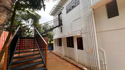 a stairway leading up to a white building at Wayanad Haven Villa in Wayanad