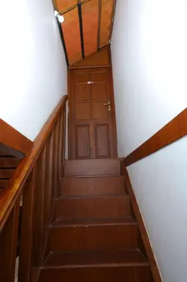 a set of stairs with a wooden door in a building at SS Farms By Shivalaya Stays in Alāndurai