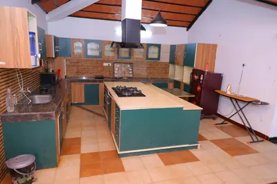 a large kitchen with a stove and a sink at SS Farms By Shivalaya Stays in Alāndurai
