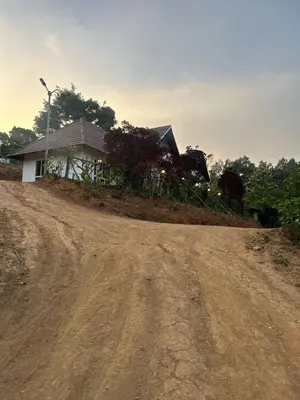 a dirt road in front of a house at Kashmir Valley Alpha in Kanthalloor