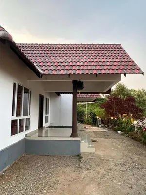 a house with a red tile roof on it at Kashmir Valley Alpha in Kanthalloor