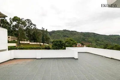a balcony with a view of a mountain at EKOSTAY - Amber Villa in Kodaikānāl