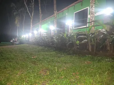 a row of lights on the side of a house at night at Green wayanad homestay in Kenichira