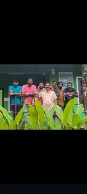 a group of men standing behind a fence at Green wayanad homestay in Kenichira