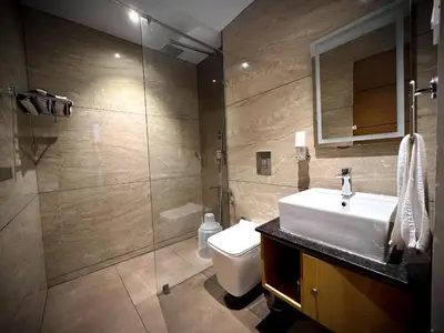 a bathroom with a sink and a toilet and a shower at Talenresort Vythiri Villas in Wayanad