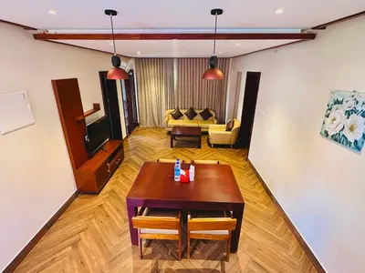 a living room with a table and a couch at Talenresort Vythiri Villas in Wayanad