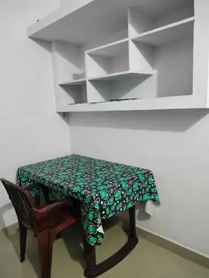 a small table with a green and white table cloth on it at Aswathy Bhavan in Vadakkāncheri