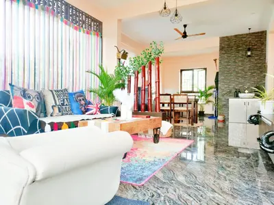 a living room with a couch and a table at Tranquil Traditions Homestay - Inspired by Nature & Heritage in Mysore