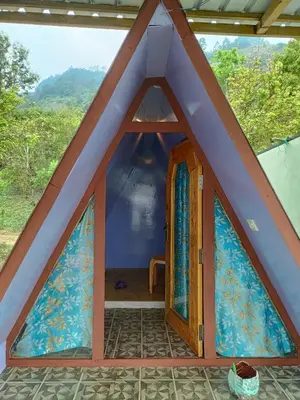 a room in a tent with a door at Croods cabin in Kodaikānāl