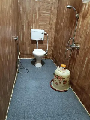 a bathroom with a toilet and a shower at Croods cabin in Kodaikānāl