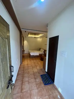a room with a bedroom with a bed and a television at City Centre in Coimbatore