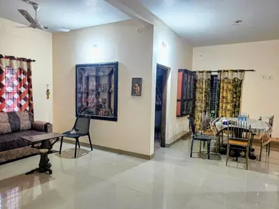 a living room with a couch and a table at Coffee View Holiday Homes in Thirunelli