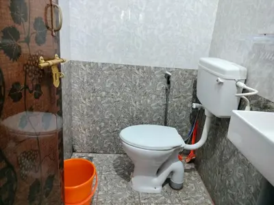 a bathroom with a toilet and a sink at Aswathy Bhavan in Palakkad