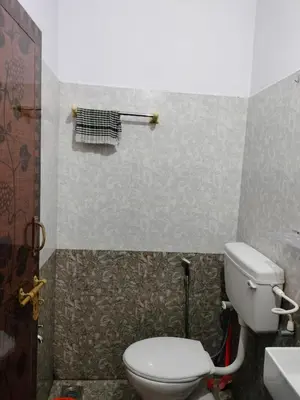 a bathroom with a toilet and a sink at Aswathy Bhavan in Palakkad