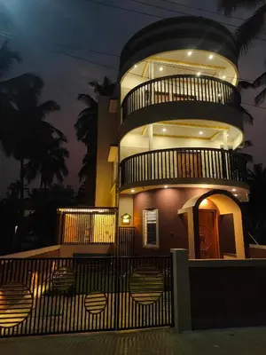 a large building with a round tower at night at G3 nest in Mysore