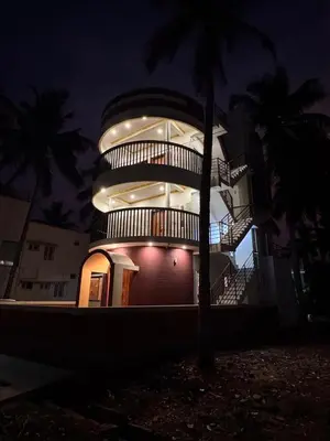 a large building with a spiral staircase on it at night at G3 nest in Mysore