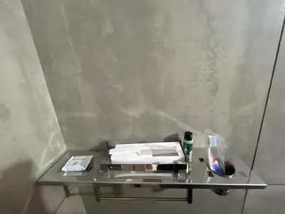 a glass table with a stack of papers on it at Hotel Le Marina Residency in Kozhikode