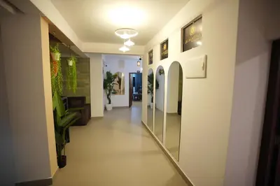 a hallway in a building with plants on the walls at Hotel Le Marina Residency in Kozhikode