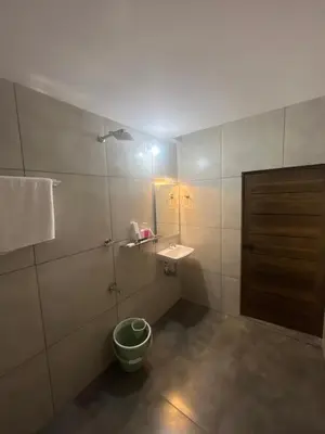 a bathroom with a sink and a toilet in it at Hotel Le Marina Residency in Kozhikode