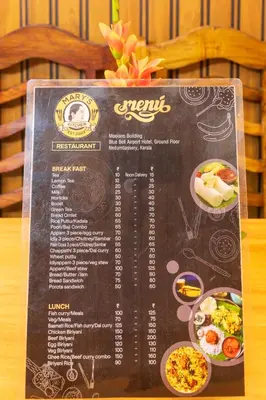 a menu for a restaurant with food on a table at Sancta Maria Lounge -cochin Airport in Nedumbassery