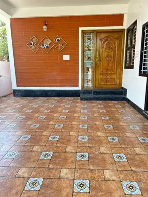 a front door of a house with a tile floor at Franklin's Finestay in Kotagiri