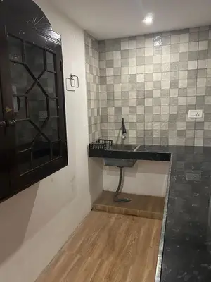 a bathroom with a black sink and a shower at Franklin's Finestay in Kotagiri