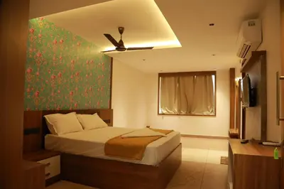 a bedroom with a bed and a painting on the wall at Marina Tower & Regency Changaramkulam in Edappāl
