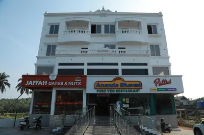 a large white building with a store front at Marina Tower & Regency Changaramkulam in Edappāl