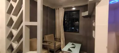 a living room with a chair and a window at Cocoa Tree Munnar in Munnar