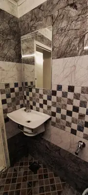 a bathroom with a sink and a mirror at Cocoa Tree Munnar in Munnar
