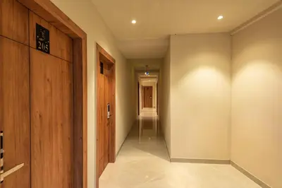 a hallway with a door and a walkway at Hotel Beverly Palace Kozhikode - Hotel and Restaurant in Kozhikode